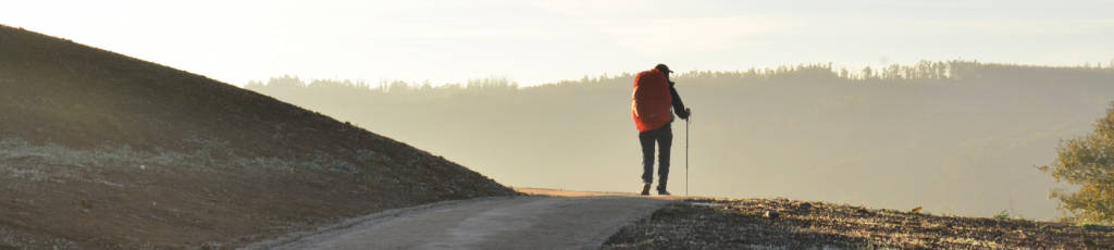 Man walking solo over some hills